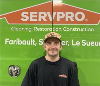 SERVPRO employee in front of green truck