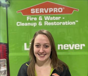 SERVPRO employee in front of green truck