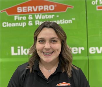 SERVPRO employee in front of green truck